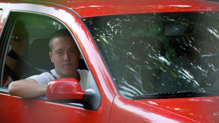 paparazzi1020638 Little red VW Golf approaching the lake